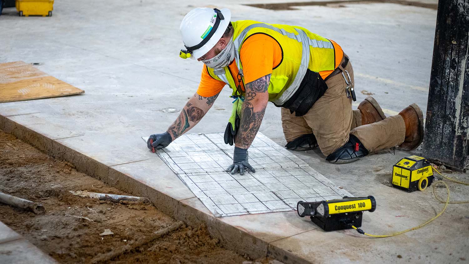 A construction worker is scanning concrete using GPR technology.