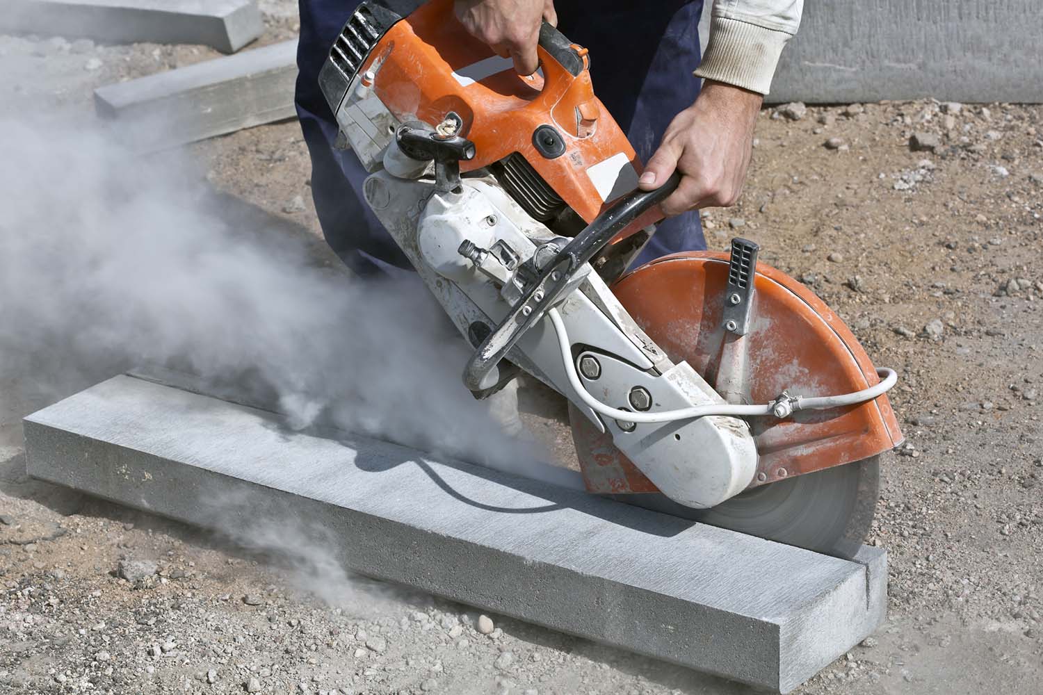 A man sawing concrete.
